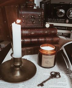 a candle and some books on a table