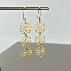 "Flower Earrings Linear Earrings Drop Earrings Dangle Earrings Bohemian Earrings Filigree Earrings Dainty Earrings Lace Earrings Gift for her These beautiful linear lightweight Daisy earrings have a delicate blend of femininity and edge. Light enough for every day yet filled with elegant beauty for your special occasions. Material: Gold Plated Brass / Silver Plated Brass Length - 2\" Width: 6/16' Earring Backings: Each pair of earrings includes a set of clear rubber stoppers. All my jewelry come Lace Earrings, Elegant Beauty, Filigree Earrings, Daisy Earrings, Earrings Bohemian, Earrings Dainty, Bohemian Earrings, Oct 1, Earrings Drop