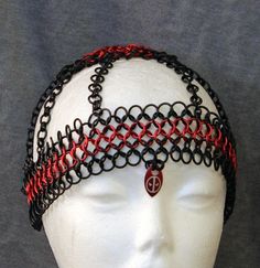 This chainmail headdress is made from three sizes of anodized aluminum rings in red, and black.  It features a red anodized aluminum scale on the forehead which is etched with the Deadpool symbol. It is very light and will fit most adult sizes.  It is shown on a 20 inch model head and should fit up to a 24 inch (60 cm) head or so.  It will sit exactly as on the model for a smaller head and a little higher on a larger head. Chainmail Headdress, Deadpool Symbol, Super Hero Costume, Hair Jewellery, Hero Costumes, Costume Cosplay, Super Hero Costumes, Anodized Aluminum, Chain Mail