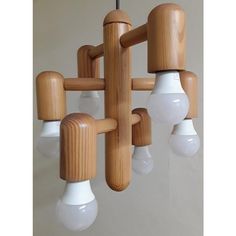 a wooden chandelier with five light bulbs hanging from it