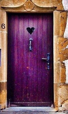 a purple door with two hearts on it