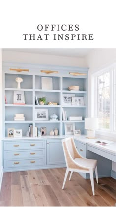 a home office with blue painted cabinets and white desks in front of large windows