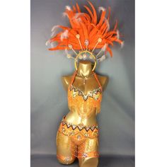 a mannequin with feathers on it's head and an orange bra top