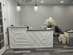 the front desk of a hair salon with flowers on it