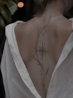 the back of a woman's neck with flowers on it