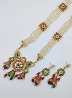 Gifting: This Indian long necklace set comes in a beautiful Tarinika gift box, making it an ideal gift for birthday, wedding anniversary or wedding gift. Care: It is advisable that you keep Tarinika products away from direct heat, humidity, and moisture. It is best to preserve your Tarinika jewelry in the box. Elegant Multicolor Jewelry Sets For Diwali, Multicolor Jewelry Sets With Intricate Design For Celebration, Traditional Bridal Necklace With Matching Earrings For Festivals, Red Jewelry Sets For Diwali Gift, Kundan Necklaces For Diwali Gift, Kundan Necklace With Latkans For Gift, Traditional Necklace With Matching Earrings For Festivals, Diwali Jewelry Sets With Matching Earrings For Celebration, Diwali Celebration Jewelry Sets With Matching Earrings