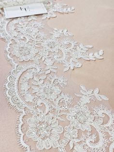 "Quantity available. Please \"Add to cart\" to see available quantity. Off white lace trim with pearl embroidery, sold by the yard. Width: 19 cm/7.5 inches Item number: EEV2147 Made in Europe www.LaceToLove.com Price is set for one meter/yard.  You will receive the fabric in one continuous piece if you purchase more than 1 meter/yard. Actual color may vary greatly form the color you see on screen. It depends on your devices screen brightness/settings. We recommend you to buy a sample before ordering to see the true color. You can purchase a sample here: https://www.etsy.com/listing/248526479/buy-a-swatchsample?ga_search_query=sample&ref=shop_items_search_1 All orders are shipped in one business day. We ship worldwide via Priority mail from Latvia (EU). Estimated delivery time: USA/Canada: Pearl Embroidery, Pearl Lace, Pearl And Lace, Wedding Lace, Lace Bridal, Chantilly Lace, Lace Weddings, French Lace, Off White Color