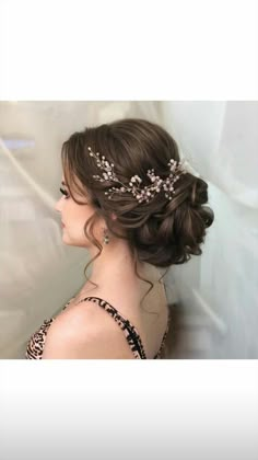 a woman wearing a tiara with flowers in her hair