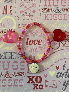 This is a Valentine Love Bracelet. It would make a great gift for a teen girl for Valentines Day. It would make a great gift for a teen girl's Birthday. It has a silver love charm in the middle. It has pink, hot pink, and orange seed beads. It was made with .8mm sturdy stretch string. I tie it several times to prevent breakage. It fits most teens and women. It stretches to fit on the wrist. All items are ready to be shipped I do combined shipping. Items ship in 2-5 business days. Check out more Seed Bead Bracelet, Bracelet Love, Love Bracelet, Valentine Love, Love Charms, Seed Bead Bracelets, Bracelets For Women, Love Bracelets