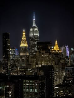 the empire building is lit up at night in new york city's financial district