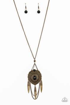 Paparazzi Accessories-Cactus Canyon - Brass Necklace Item #P2TR-BRXX-086XX Earthy black beads are pressed into a stacked brass pendant embossed with ornate circular patterns. Swinging from the bottom of a lengthened brass chain, the colorful pendant gives way to layered brass chains and brass beads radiating with swirling textures for a tribal inspired finish. Features an adjustable clasp closure. Black Brass Festival Jewelry, Bronze Metal Necklace With Antique Finish, Bronze Antique Finish Metal Necklace, Ornate Metal Necklaces With Vintage Charm, Vintage Brass Long Necklace With Charm, Vintage Brass Long Necklace, Black Bohemian Brass Necklace, Bronze Engraved Necklace For Festivals, Bohemian Black Brass Necklace