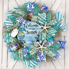 a blue and white wreath with a starfish on it that says, may you always have shells in your pocket