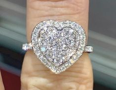 Gorgeous Heart Shape Diamond Ring Set in 18K White Gold. 1.00 full carats of diamonds.  The diamonds are all white and very sparkling.  Also the diamonds are set smooth so won't catch on anything.  Heart measures about 14mm. The band is 2mm width.   Natural Round Brilliant Cut Diamonds Total Weight: 1.00 carats Clarity: SI Color: G Diamonds are clear and super sparkly, not cloudy or yellow.   OUR DIAMONDS ARE 100% NATURAL AND NOT CLARITY ENHANCED OR TREATED 18K White Gold Setting 4.64 grams of Solid Gold Stock ring size 6  Ring Comes with Gift Box #14700GS * We have been in the wholesale Jewelry business for over 30 years serving the community at the same location.  All diamonds we use are natural stones and fine quality gold.  Absolutely NO clarity enhanced or treated diamonds. Our jewelr Engagement Ring Heart Shape, Heart Shape Diamond Ring, Betty Boop Jewelry, Heart Shaped Diamond Engagement Ring, Engagement Ring Heart, Ring Heart Shape, Heart Diamond Ring, Heart Shaped Diamond Ring, Heart Promise Rings