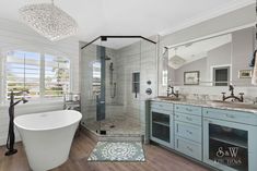 a bathroom with a tub, sink, and shower in the middle of the room