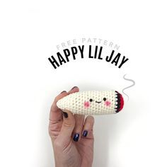 a person holding a knitted object with the words happy lil jay on it