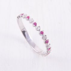 Small Dainty Ruby Wedding Band, Minimalist Wedding Band, Womens Ruby Ring, Ruby Silver Ring, Tiny Wedding Band, Delicate Wedding Band WE OFFER UNLIMITED PERIOD INSTALLMENTS PLAN This is a beautiful, stunning, feminine ring that works well for all occasions, styles, and ages. You will love it! Ring information: Stone: Ruby Approximate size: 1.5mm (9 stones) Stone: White cubic zirconia Approximate size: 1.5mm (9 stones) Metal type: Silver Metal stamp: 925 Sterling Silver Installment Payments We of Elegant Stackable Ruby Wedding Ring, Elegant Stackable Ruby Ring For Wedding, White Ruby Ring With Prong Setting For Wedding, Dainty Adjustable Wedding Ring, Stackable Round Ruby Ring For Wedding, Dainty Sterling Silver Ruby Wedding Ring, Dainty Sterling Silver Ruby Ring For Wedding, Adjustable Silver Wedding Birthstone Ring, Elegant Adjustable Ruby Wedding Ring