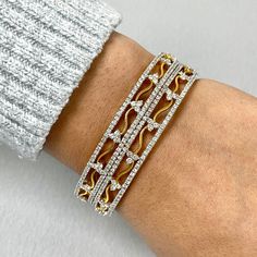 The Sheena Bangles draw on Indian heritage with their sweet flowery details and gentle curves. They are a sweet and elegant pair. Total Diamond Weight: 10.59 ct No. of Diamonds: 552 Diamond Color: G - HDiamond Clarity: VS - SI (Very Slightly Included - Slightly Included) Metal: 18K Yellow Gold Metal Wt: 35.48 gms Setting: Prong Set Inner Diameter: 2.5 Inches (6.35 cm) Diamond Cut Diamond Bangle For Wedding, Diamond Cut Bangle For Wedding, Fine Jewelry Diamond Accents Bangle For Wedding, Diamond White Fine Jewelry Bangle For Wedding, Diamond White Wedding Bangle Fine Jewelry, Fine Jewelry Wedding Bangle With Diamond Accents, Yellow Gold Diamond Bracelet For Wedding, Wedding Fine Jewelry Bangle With Diamond Accents, Wedding Fine Jewelry Diamond White Bangle