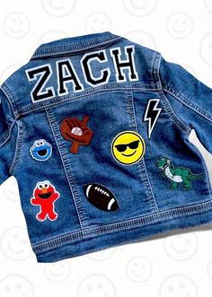 This custom denim jacket makes the perfect gift for kids of all ages.   From a new baby gift, to first birthday outfit, to a totally awesome jacket to wear to school. Name or monogram  is always included.  Please choose letter type & # of patches in addition to name.  We have so many patches to choose from (not just the samples shown in photos).  Please let us know any favorites / must haves for the kids (colors, hobbies, etc).  This jacket should be as unique and special as the kid wearing it!  Please specify if you would like a preview before patches are secured. This may delay shipping and processing. We promise to be timely in our responses and request that you do the same. Patches are first applied with heat and then machine sewn on for longevity.  However, jacket should always be was Jean Jacket With Patches, Patch Jean Jacket, Boys Jean Jacket, Toddler Boy Jeans, Custom Jean, Jean Jacket Patches, Custom Jean Jacket, Jacket With Patches, Toddler Christmas Gifts