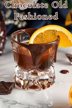 a chocolate old fashioned cocktail garnished with an orange slice