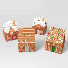 three gingerbread houses are shown on a white background