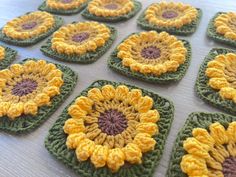 crocheted coasters with yellow and green flowers on them sitting on a table