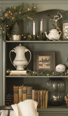 a book shelf filled with christmas decorations and books on top of it's shelves