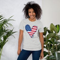 a woman wearing a t - shirt with an american heart on it