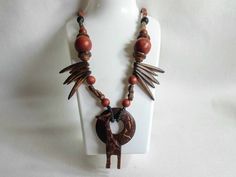 Lovely vintage African necklace. Artisan made wooden necklace. Hand carved Giraffe. Tribal theme. Unusual. Length 62cm ex pendant. Gift idea. Free Shipping Free shipping  from my vintage store, Bags Of Fun in Cyprus. If you are outside of the EU customs charges may apply.   Non-EU customers need to provide a Telephone number and/or email address for the Custom's Declaration (this is not included on the envelope). This is required in case Customs need to contact you regarding your order.  If you' Unique Carved Brown Necklace, Unique Brown Carved Necklace, Brown Carved Pendant Necklace, Brown Carved Round Bead Necklaces, Brown Carved Round Beads Necklaces, Brown Wooden Beads Pendant Jewelry, Brown Wooden Bead Pendant Jewelry, Brown Wooden Beads Pendant Necklace, Adjustable Carved Brown Necklace