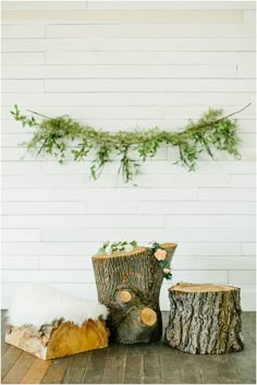 two wooden logs sitting next to each other on top of a wood floor covered in snow