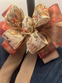 a bow that is sitting on top of someones lap and has money printed on it