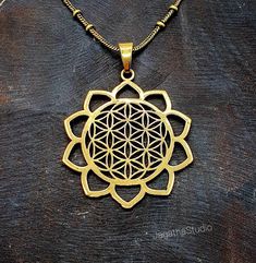 HANDMADE Beautiful Flower of Life pendant with a complementary decorated chain. The Flower of Life is a sacred power symbol of the connections life weaves through all beings. It is believed to contain the patterns of creation and fundamental forms of space and time.  Made by hand with hight quality of brass, Nickel free.  SIZE Aprox diameter pendant: 5.6 cm Aprox Pendant Diameter: 4.2 cm The chain is available in different lengths and pattern/style: -Knot chain (as per picture) available in 43 a Spiritual Bronze Nickel-free Jewelry, Symbolic Bronze Jewelry For Gift, Cadmium-free Bronze Jewelry Gift, Spiritual Round Pendant Metal Jewelry, Spiritual Metal Jewelry With Round Pendant, Spiritual Metal Round Pendant Jewelry, Spiritual Metal Jewelry With Adjustable Chain, Bohemian Necklace With Flower Pendant, Bohemian Metal Jewelry With Flower Charm