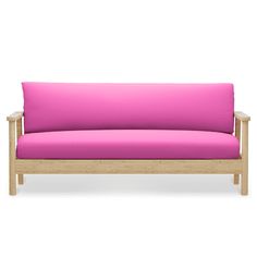 a pink couch sitting on top of a wooden frame