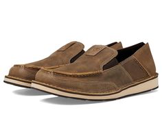 Ariat Cruiser - Men's Slip on  Shoes : Brown Bomber/Relaxed Bark : The Ariat Cruiser is the perfect slip-on shoe for weekend road trips, hanging out with friends, and of course, for kicking back on your favorite cruise. Easy slip-on shoe. Leather upper. Breathable textile lining. Cushioned footbed features Ariat's exclusive ATS Technology for the ultimate combination of flexibility and cushioning. Ariat's exclusive ATS Technology shank features composite fiber material in wide forked shape through the midrange of the foot, providing three times the support and stability of a traditional steel shank. Flexible rubber outsole provides comfort and traction. Style Number: 10033931, 10023208, 10040361, 10044535, 10017454, 10023210, 10024919, 10027395, 10031524, 10046939, 10046940, 10019871 Impor Rugged Cushioned Slip-on Walking Shoes, Outdoor Leather Footbed Slip-ons, Rugged Brown Slip-on Loafers, Casual Slip-ons With Leather Footbed And Moc Toe, Leather Slip-on Loafers For Outdoor, Outdoor Slip-on Loafers With Leather Footbed, Classic Round Toe Slip-ons For Outdoor, Ariat Cruisers, Mens Business Casual Shoes