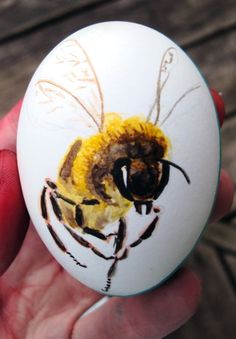 a painted egg with a bee on it