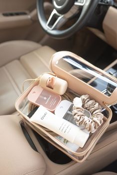 an open purse sitting on top of a car seat