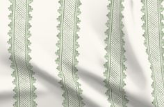 a white background with green lace on the bottom and side, as well as a ruler