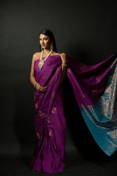 Get ready to turn heads with this stunning silk saree! The beautiful purple and azure blue color combination of this Silk saree will make a strong statement no matter where you go. Intricate gold embroidery work along the pallu adds a bit of traditional flair that makes this saree perfect for special occasions. Whether you're attending a wedding or hitting up an office party, this classic yet eye-catching look is sure to make your mark on any setting. Plus, you'll stay comfortable since the lush Purple Silk Handloom Pre-draped Saree, Purple Paithani Silk Pre-draped Saree For Wedding, Purple Pre-draped Saree For Puja, Purple Katan Silk Pre-draped Saree With Zari Work, Designer Purple Tussar Silk Traditional Wear, Purple Paithani Silk Saree In Traditional Drape, Designer Purple Paithani Silk Dupatta, Purple Pre-draped Saree With Traditional Pallu, Purple Silk Pre-draped Saree With Zari Weaving