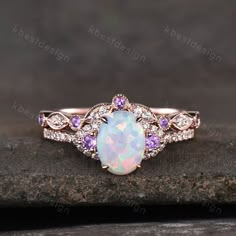 This is a beautiful lab created white fire Opal engagement ring in rose gold. Main Stone: 6x8mm oval cut opal. Side stone: Amethyst + Moissanite. Wedding band: Curved band, Moissanite.. This ring is marked G10K/G14K. I accept custom making order.Please contact me if you need this service. For all the jewelries,there is a 14 days money back guarantee.You can return it in the time frame without any questions.However there maybe handcrafted fee and shipping fee deducted from the original payment as Gold Opal Engagement Ring, Ruby Engagement Ring Set, White Opal Engagement Ring, Opal Engagement Ring Rose Gold, Wedding Band Curved, Fire Opal Engagement Ring, Opal Engagement Ring Set, Oval Cut Ring, Cute Engagement Rings