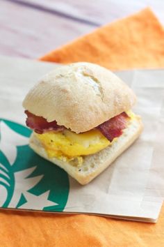 an egg and bacon sandwich on a starbucks bag