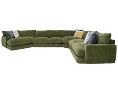 a green sectional couch with pillows on it's back and arms, sitting in front of a white background