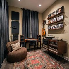 a living room filled with furniture and a guitar on top of a rug in front of a window