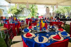 tables set up for an event with red, white and blue linens