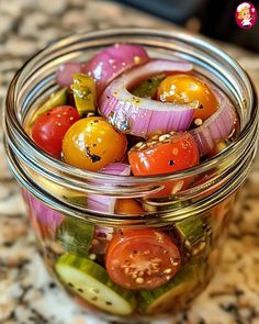 a glass jar filled with lots of different types of vegetables