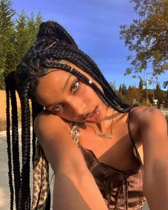 a woman with dreadlocks posing for the camera