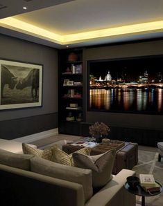 a living room filled with furniture and a flat screen tv mounted to the side of a wall