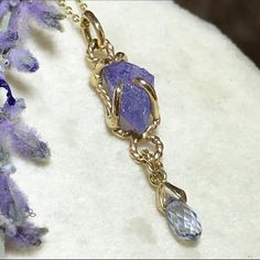 "Please go to my Instagram to watch the video about this pendant ~ A lovely genuine purple-blue color tanzanite glistens in a hollow 14k yellow gold wire bezel.  Set with a light blue color sapphire bead is so fiery, vibrant and intense!  A unique little piece with so much character. All handcrafted by me in my Michigan studio. Gem: approx. 12mm x 7mm / 2.15ct / genuine purple-blue tanzanite / with inclusions and imperfection surface            6mm x 3mm/ genuine light blue bead / with inclusion Handmade Tanzanite Yellow Gold Jewelry, Unique Tanzanite Jewelry Gift, Unique Tanzanite Jewelry For Gifts, Lavender Tanzanite Jewelry For Gifts, Necklace Sapphire, Boulder Opal Ring, 14k Yellow Gold Necklace, Halo Necklace, Yellow Gold Necklace