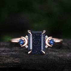 "This is a  Lab blue sandstone engagement ring in solid gold,about 6X8mm emerald cut. The accent stones are lab sapphires and moissanites. The band width is about 1.3mm. It can be made in any ring size. However please contact me to custom make it to a special big or small size. It can be made in white gold,rose gold or yellow gold with 14k or 18k. However for some people who are nickel allergic,I can also make it to 925 sterling silver to make you can wear it. The ring is handmade,very high quality! 30 days money back guarantee. Returns & Warranty 30-Day money back guarantee (starting from the day of delivery). \"Made to Order\" purchases qualify for our 30-day money back guarantee. The 30-day money back guarantee gives you time to make sure your purchase is perfect. If you need to  return Blue Sandstone Ring, Blue Sandstone Engagement Ring, Sandstone Engagement Ring, Sandstone Ring, Unique Engagement Rings Rose Gold, Blue Sand Stone, Sapphire Side Stones, Blue Sandstone, Ring Cluster