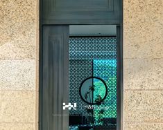 the front door to a building with a round glass window