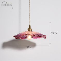 an image of a pink flower hanging from a light fixture with measurements for the length