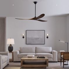 a living room filled with furniture and a ceiling fan in the middle of the room